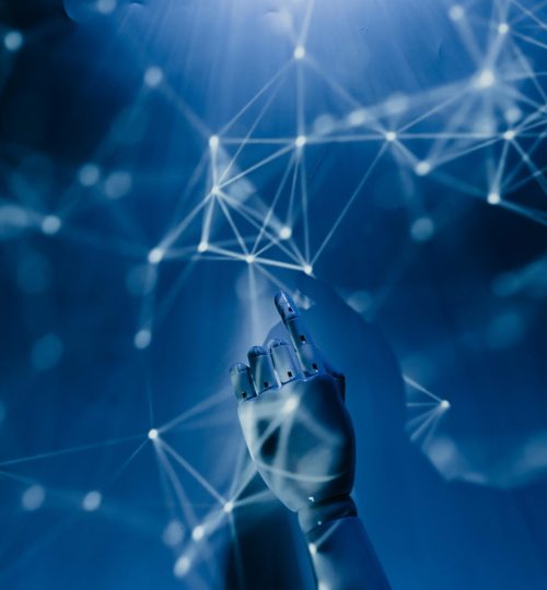 A robotic hand reaching into a digital network on a blue background, symbolizing AI technology.